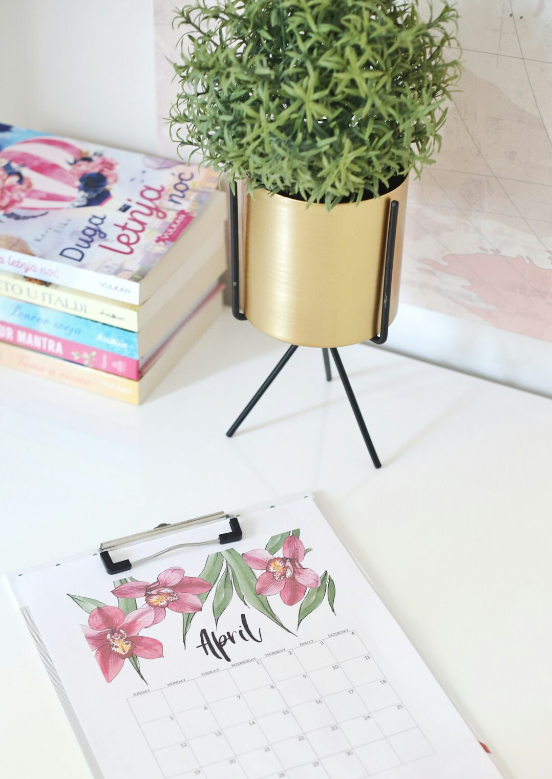 Desk with planner, notebook and plant