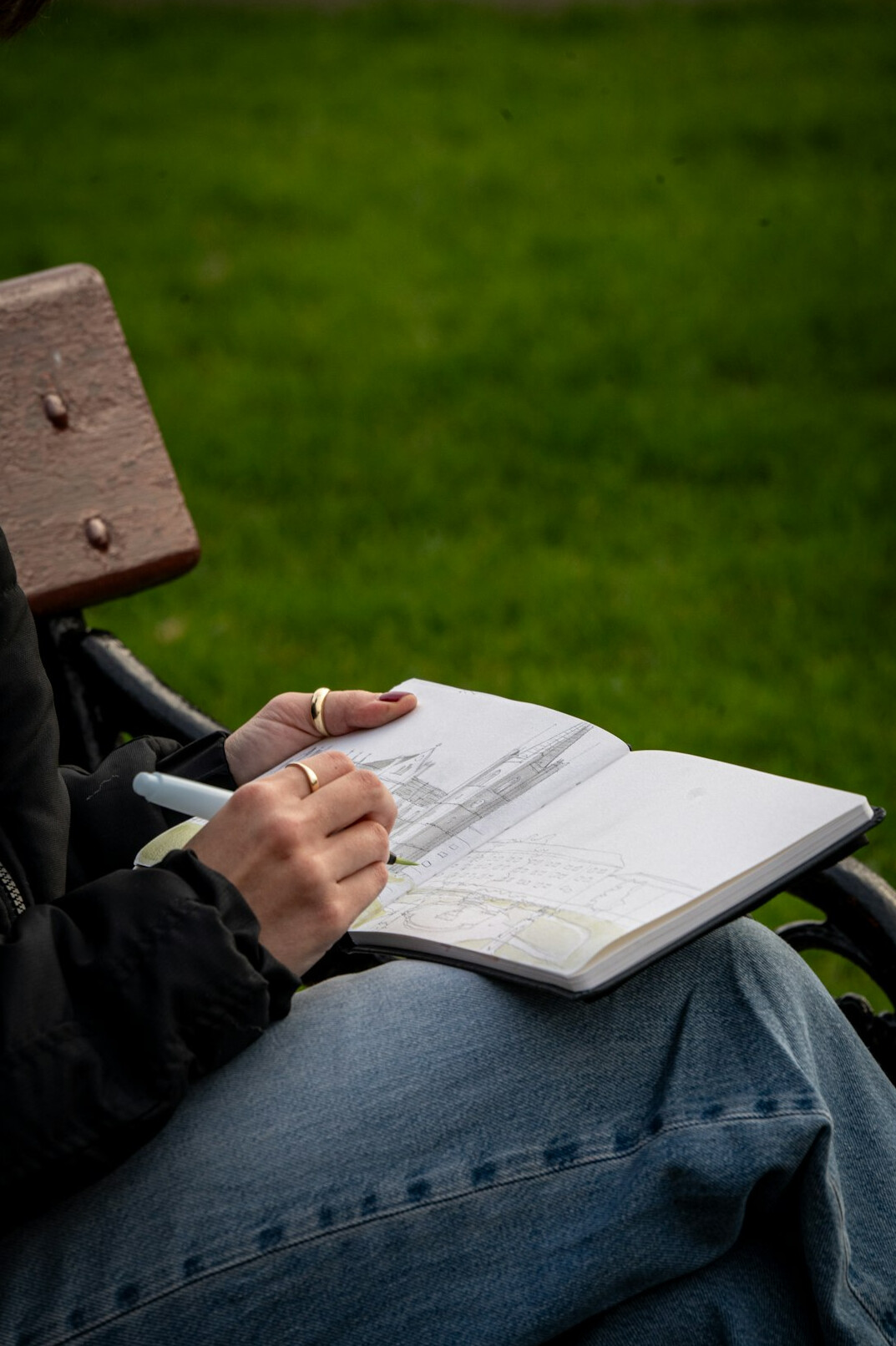 person drawing in notebook